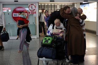 A family from Yorkshire who were living in Dubai embrace a relative, as passengers from the first government-chartered flight for British nationals, which departed from Oman, arrive at London Stansted Airport, amid the US-Israeli conflict with Iran, near London, Britain, 6 March 2026
